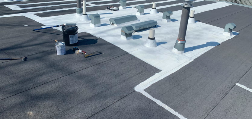 TPO roofing installation in Calgary with white reflective coating for energy efficiency and durability